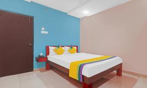um quarto com uma cama com uma parede azul em Itsy By Treebo - Aflah em Hyderabad