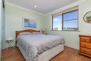 a bedroom with a bed and a window at Surfspray 3 Pebbly Beach in Forster