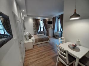a bedroom with a bed and a table and a dining room at Placeta Apartments in Dubrovnik