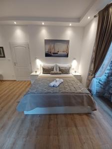 a bedroom with a large bed with two towels on it at Placeta Apartments in Dubrovnik