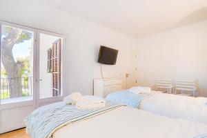 En eller flere senger på et rom på Ses Alzines Apartment - Costa De Los Pinos