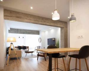a living room with a wooden table and a dining room at Guardaviñas62 in Logroño