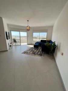 a large living room with a couch and a table at Rothschild Royal in Ashdod