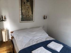 a bedroom with a bed with two towels on it at Austeria Zakościele in Inowłódz