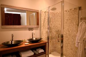 a bathroom with two sinks and a shower at Château de Pymont in Boyer