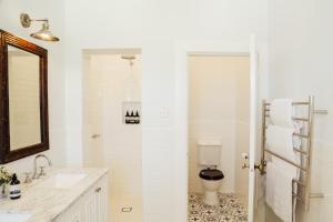 a bathroom with a toilet and a sink and a mirror at Mount William Station in Willaura