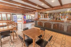 a restaurant with tables and chairs and a bar at HOSTAL RIO ARA BELLOSTA by Vivere Stays in Fiscal