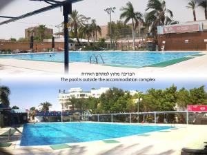 a large swimming pool in a city at Mali Country Hospitality in Eilat