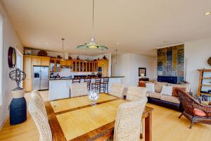 a kitchen and living room with a wooden table and chairs at The Coquille River Retreat in Bandon