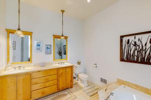 a bathroom with a sink and a toilet and a tub at The Coquille River Retreat in Bandon +34 photos