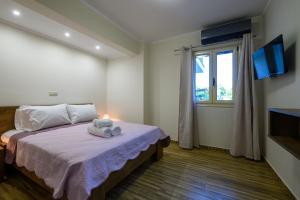 a bedroom with a bed with a stuffed animal on it at KV Apartments Kalamata in Kalamata