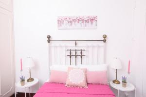 A bed or beds in a room at Luccil's Home Downtown