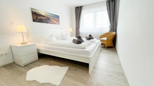 a bedroom with two beds with teddy bears on them at Ferienwohnung Nordseebrandung B3.1 in Sahlenburg