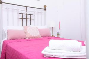 A bed or beds in a room at Luccil's Home Downtown