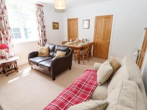 a living room with a couch and a table at East Farm Cottage in Lincoln