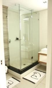a bathroom with a glass shower and a toilet at The crystal towers one-bedroom studio in Cape Town