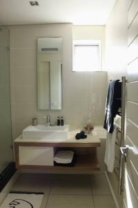 a bathroom with a sink and a mirror at The crystal towers one-bedroom studio in Cape Town
