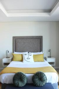a bedroom with a large bed with a face drawn on it at The crystal towers one-bedroom studio in Cape Town
