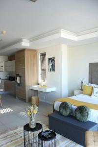a bedroom with a bed and a living room at The crystal towers one-bedroom studio in Cape Town