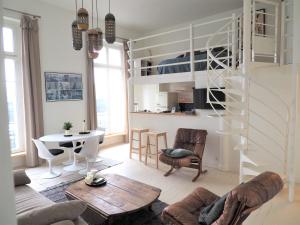 a living room with a loft bed and a table at Le Bigorneau , beach at 20m and free private carpark in Saint Malo