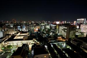 a view of a city at night with lights at Citadines Central Shinjuku Tokyo in Tokyo