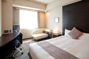 a hotel room with a bed and a desk at Citadines Central Shinjuku Tokyo in Tokyo
