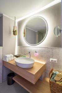 a bathroom with a white sink and a mirror at Landhotel Rittmeister & Kräuter-SPA in Rostock