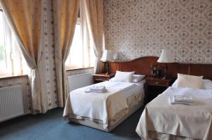 Ένα ή περισσότερα κρεβάτια σε δωμάτιο στο Hotel MERTIN