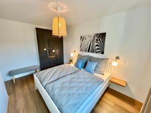 1 dormitorio con 1 cama y una foto de cebra en Fewo Jever Haus Kachelotplate, en Hooksiel