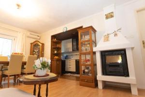 a living room with a fireplace and a table at Apartment A&A Makarska in Makarska