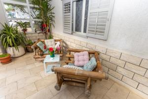 a patio with two chairs and a table at Apartment A&A Makarska in Makarska
