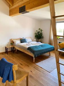 a bedroom with a bed with a blue blanket at Gasthaus Canow in Wustrow