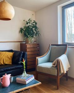 a living room with a couch and a chair at Gasthaus Canow in Wustrow