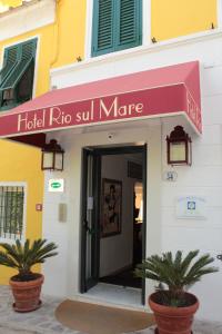 a building with a sign on the door of it at Hotel Rio Sul Mare in Rio Marina