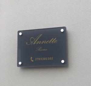 a black plaque on a wall with handwriting on it at Annette Rooms in Bari