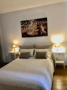 a bedroom with a large white bed with two lamps at Connie's home in Lugano