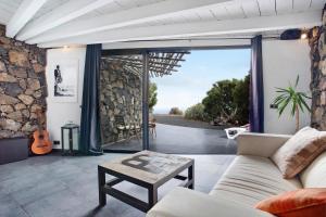 a living room with a couch and a table at La Bodeguita House in Haría +15 photos