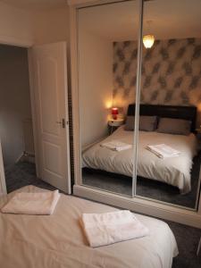 a mirror in a bedroom with a bed and a bed sqor at Hello Middlesbrough in Middlesbrough