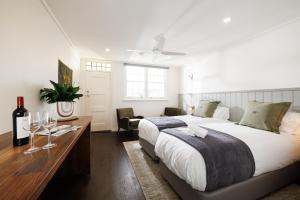 a bedroom with a bed and a desk with wine glasses at Richmond Inn in Richmond