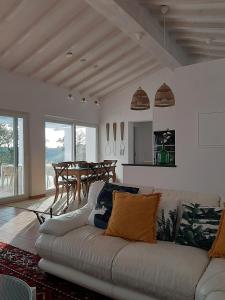 a living room with a couch and a table at Monte Vale Manhãs by Hi Alentejo in São Bartolomeu da Serra