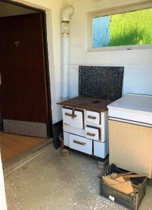 an empty kitchen with a counter and a window at Home in Banja Luka- Vikendica za iznajmljivanje in Banja Luka