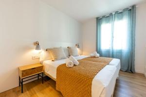 Posteľ alebo postele v izbe v ubytovaní Bravissimo Tarlà, 2-bedroom apartment