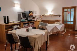 two tables with white table cloths in a room at Hotel Casa Valdese Roma in Rome