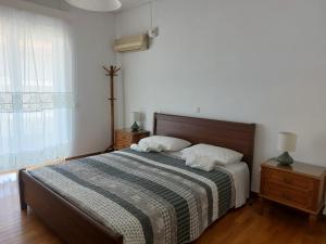 A bed or beds in a room at Sea view,big and comfortable appartment in Voula
