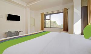 a bedroom with a large bed and a window at Treebo Trend Villa Inn Aurangabad in Aurangabad