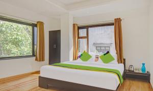 a bedroom with a large bed and a window at Treebo Villa Inn Aurangabad in Aurangabad +30 photos