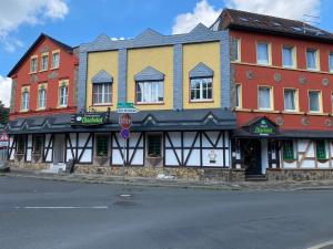 a row of colorful buildings on a street corner at Hotel & Restaurant Elbschetal in Wetter