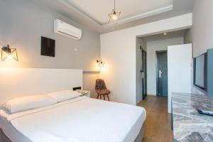 Postel nebo postele na pokoji v ubytování Aslan Sand & City Hotel