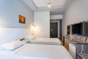 Postel nebo postele na pokoji v ubytování Aslan Sand & City Hotel