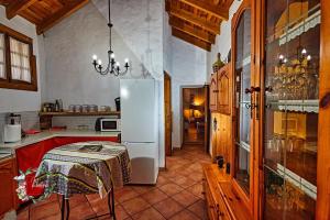 a kitchen with a refrigerator and a table in it at Finca OASIS Fataga in Maspalomas